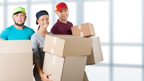 Moving boxes and furniture in a Fitzrovia apartment building